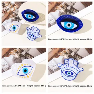 Detail view of Evil Eye and Hamsa Hand hair claws with exact size and weight dimensions