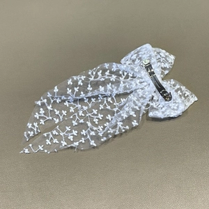 Elegant white lace bow hair clip with floral embroidery for wedding or party hairstyles