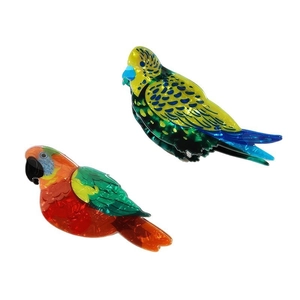 Vibrant parrot shaped acetate hair claws in green and red colors for unique hair styling