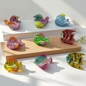 Colorful acrylic fish and bird hair clips with translucent jelly texture on white blocks