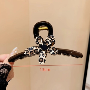Detail showing 13cm large black hair claw clip with leopard print flower decoration