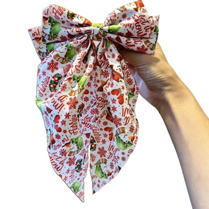 Large Christmas bow hair clip featuring snowman prints and festive Let it snow lettering