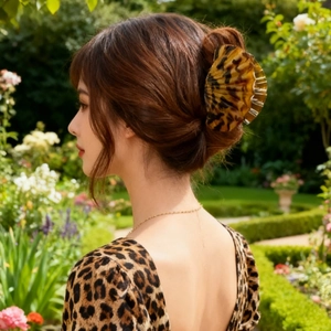 Elegant leopard print shell-shaped hair claw clip for women in a stylish updo style