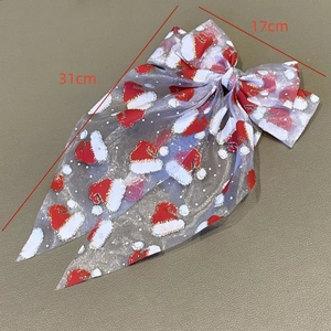 Détail du nœud de Noël montrant la taille 31cm et les motifs de bonnets de Père Noël