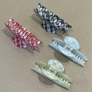 Set of four plaid and marble pattern hair claw clips for elegant ponytail styling