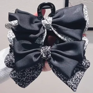 French vintage floral bow hair claw clip with black satin ribbon and white patterns