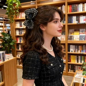 Elegant tweed plaid bow hair claw clip for women in classic black and white style