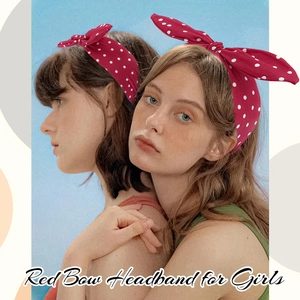 Detail view of girls wearing red polka dot bow headbands against a blue background