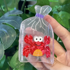 Détail d'une pince à cheveux créative avec un adorable crabe rouge de la série océan
