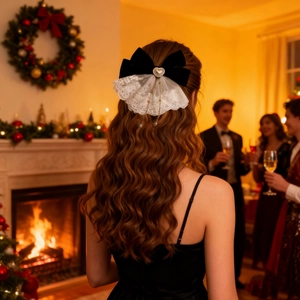 Lace bow hair clip with heart pearl pendant shown worn in a festive Christmas setting