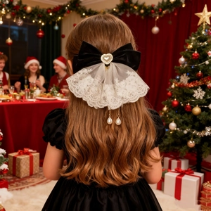Velvet bow hair clip with lace and heart pearl fringe worn on curly hair in Christmas setting