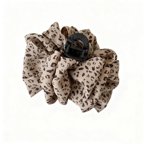 Detail of 13cm leopard print fabric hair claw clip with plush chiffon texture and spring