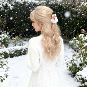 Cute snowman hair claw clip with black hat and orange scarf shown in a snowy forest setting
