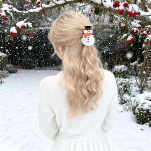 Detail view of cute snowman hair claw clip worn in hair during a snowy winter Christmas party