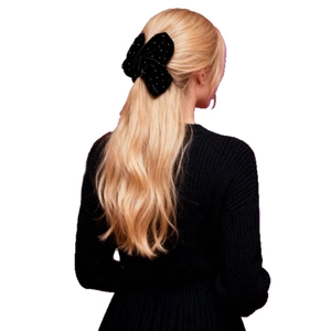 Elegant black velvet bow hair claw clip with faux pearls on blonde hair