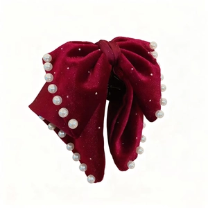 Elegant red velvet bow hair claw clip with pearl trim for festive Christmas styling