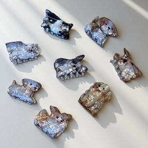 Cute dog-shaped hair claws made of marble-textured acetate in assorted breeds and colors