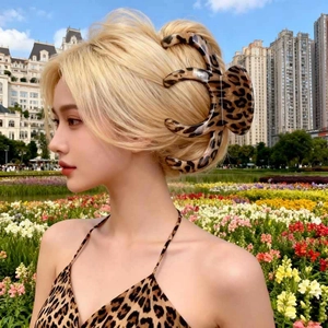 Large leopard print hair claw clip for elegant updo hairstyles shown on blonde hair