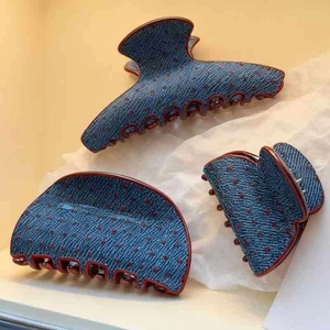Three pieces set of blue denim hair claws with red polka dots in various sizes and shapes