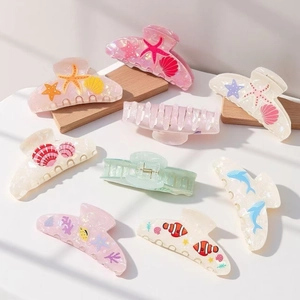 Pastel ocean series hair claws featuring sea star and clownfish designs in pearly finish