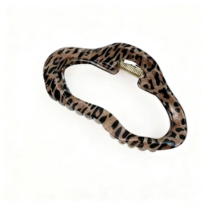 Close-up of vintage leopard print hair claw clip with unique wavy resin texture design
