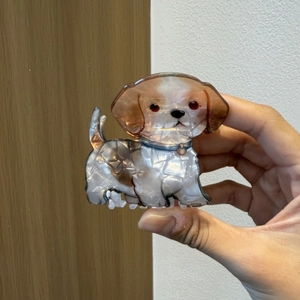 Close-up of a cute beagle dog hair claw clip made of pearlescent acetate material