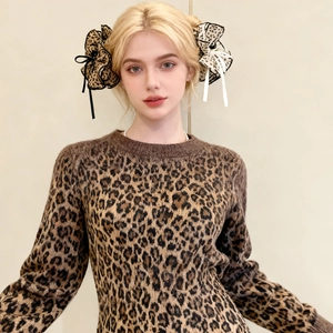 Detailed shot of leopard print double-layered bow hair claw clip with elegant ribbon