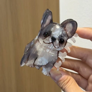 Detail of French Bulldog hair claw clip made from marble texture acetate material