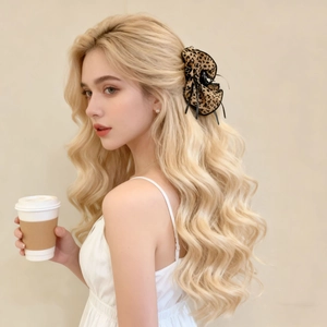 Detail of leopard print fabric bow hair claw clip styled on a woman's hair