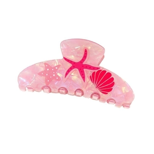 Detail of pink marble acetate hair claw with tropical starfish and seashell patterns