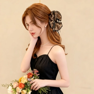French leopard print hair scrunchie with black lace trim worn by model in a side view