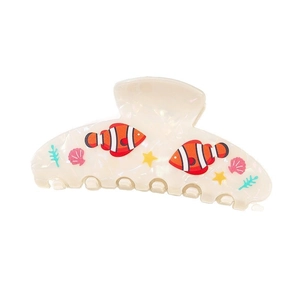 Detail of clownfish hair claw clip featuring pink shells, starfish and coral motifs