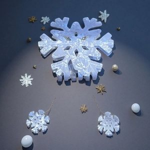 Detailed set showing snowflake hair claw and matching tassel earrings on grey background