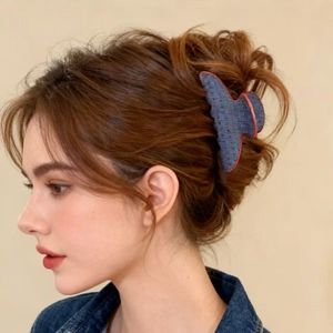 Detail showing denim texture and red polka dots on the claw clip for elegant hairstyles