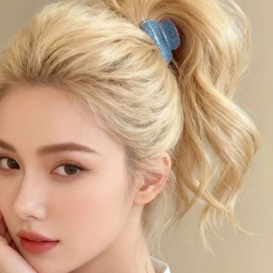 Blue glitter claw clip worn in blonde hair for high ponytail styling on beige backdrop