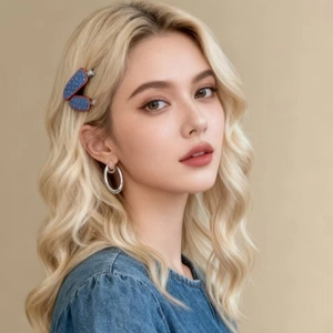 French style denim blue hair claw with red polka dots shown on blonde curly hair