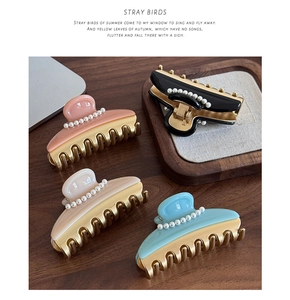 French style hair claws in pastel colors with pearl embellishments and golden metal teeth