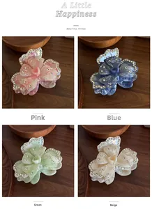 Detailed set of four floral hair claws with marble texture and rhinestone accents