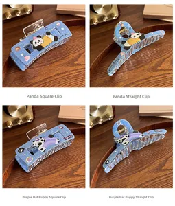 Detail of four blue denim hair claws with cute cartoon panda and puppy patches