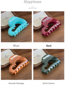 Detail view of heart-shaped hair claws in blue, red, sunset orange and dark green colors