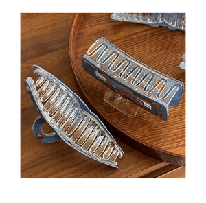 Detail of large hair claws with blue denim texture and cute rabbit pattern design