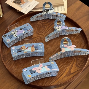 Denim blue claw clips set with cute animal patches on a vintage wooden tray