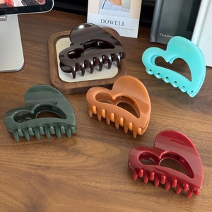 Elegant heart-shaped hollow hair claws in five vintage colors with a glossy acetate finish