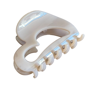 Elegant cream white pumpkin shark hair claw clip with heart cutout and polished finish