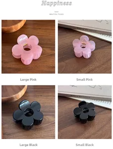 Detail of matte pink and glossy black flower hair claws in small and large sizes