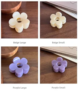 Detailed views of flower hair claws in beige and purple colors and different sizes