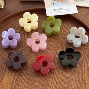 Elegant floral hair claws in eight assorted colors displayed on a premium wood tray