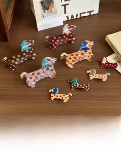Detailed view of spotted acetate dachshund hair clips in multiple retro color combinations