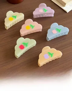 Detailed set of six pastel cloud hair clips with tulip patterns on a dark wooden table