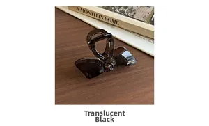 Detail view of transparent black bow hair claw clip on a vintage wooden background
